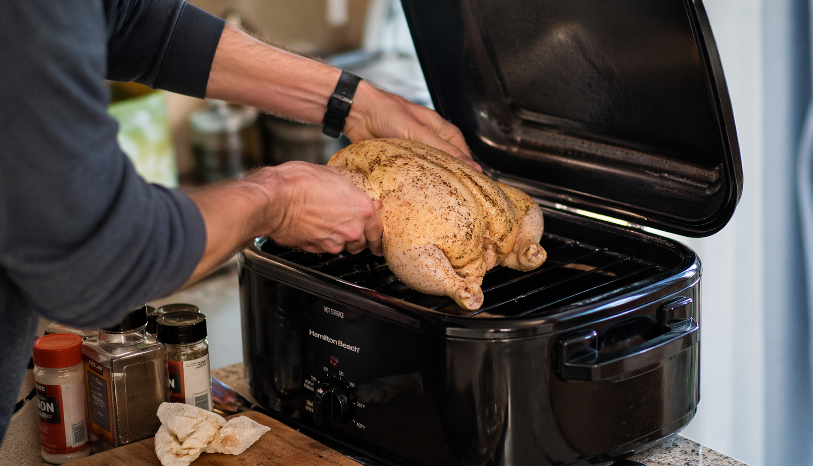 placing chicken in roaster oven on rack before cooking