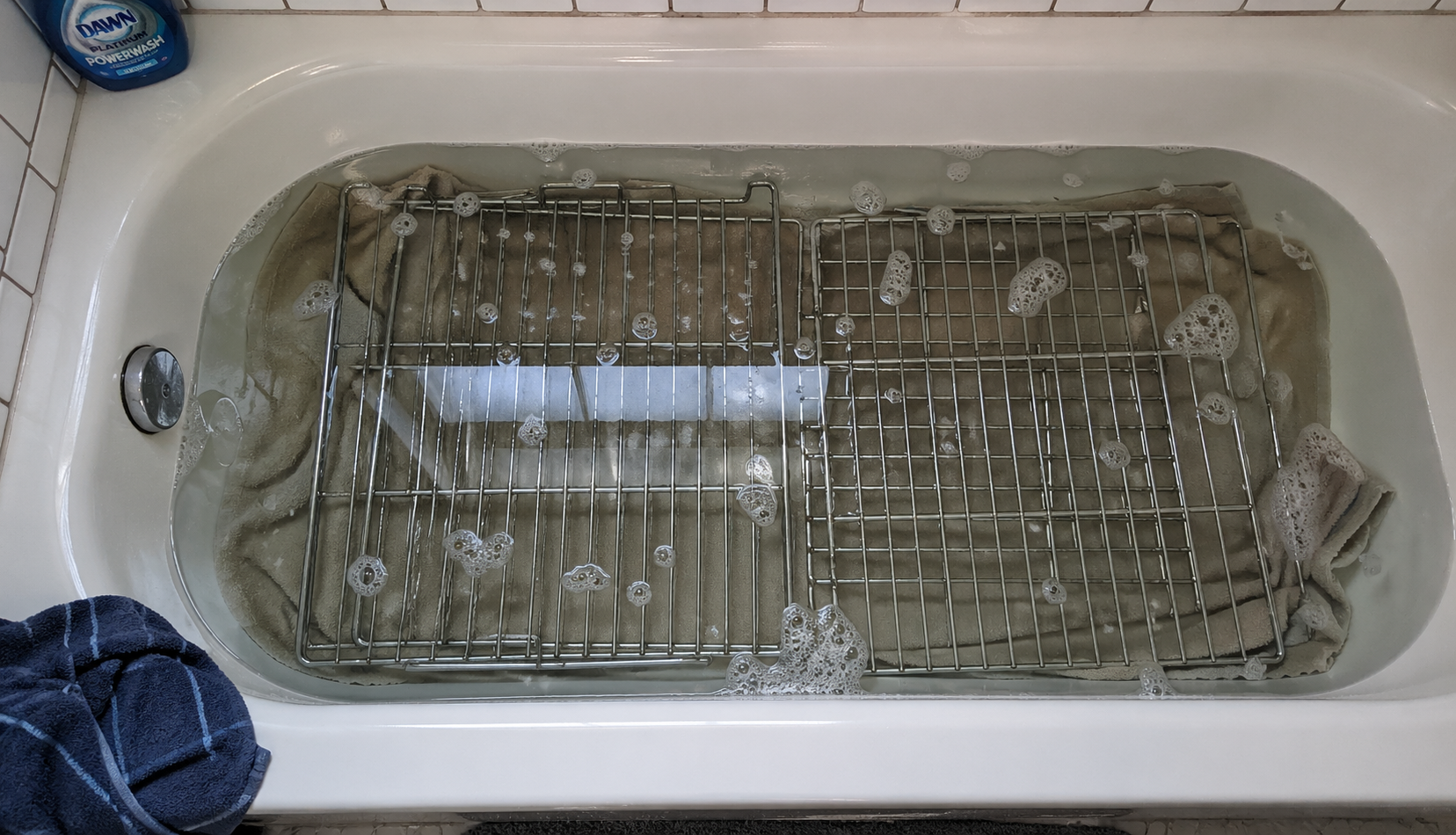 ChatGPT Image Apr 30, 2026, 12_07_25 AM oven racks soaking in bathtub with soapy water and towels