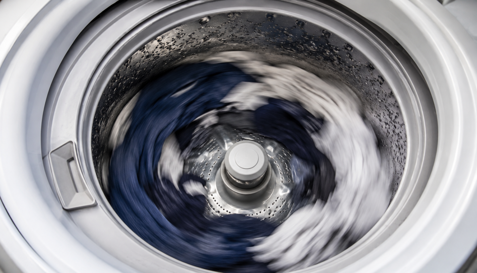 Inside top load washing machine drum during high speed spin cycle