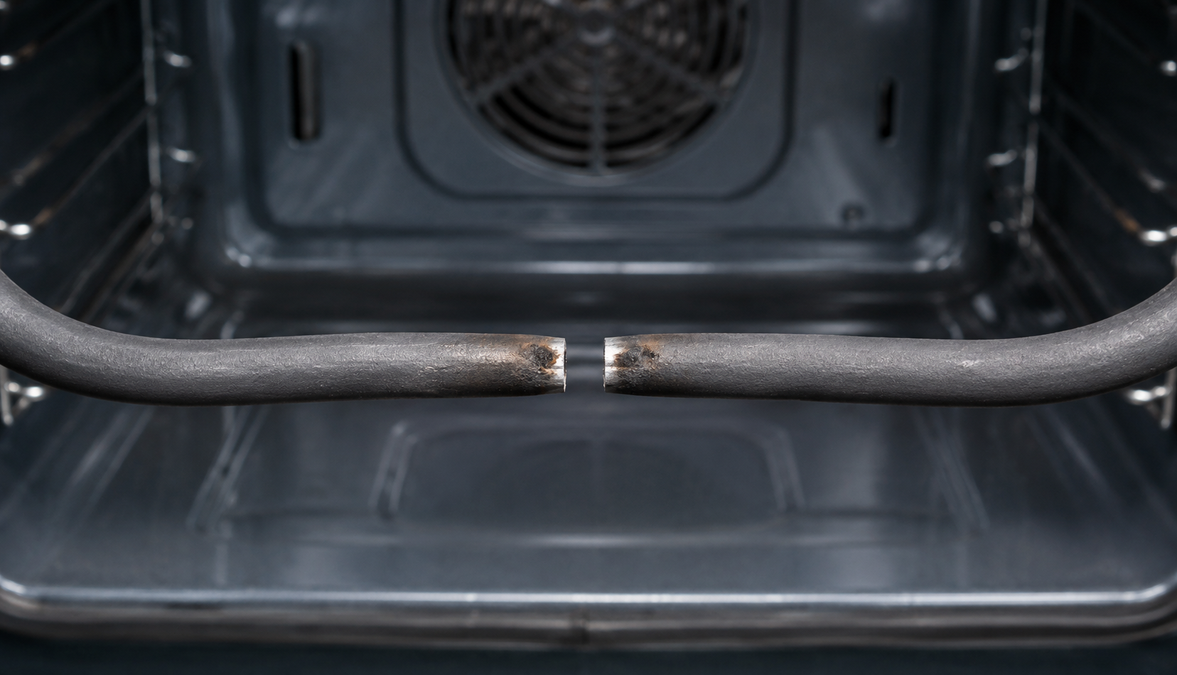 Broken bake element inside oven cavity showing visible snap and burn mark