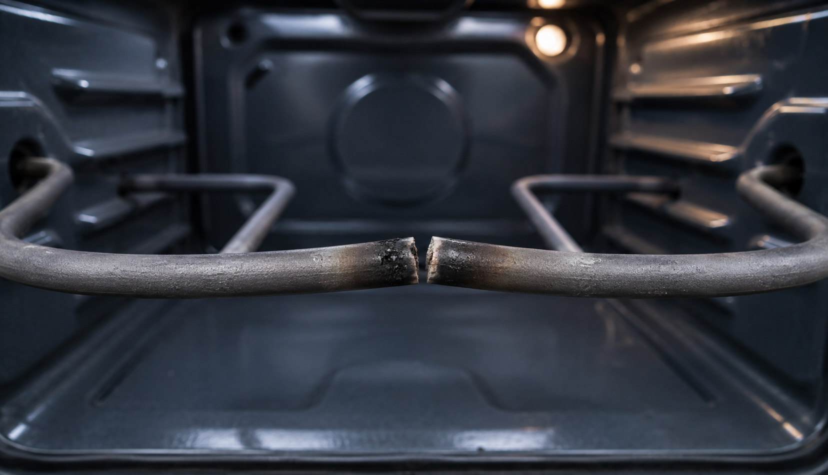 Burnt oven coil with visible break and burn mark inside oven cavity