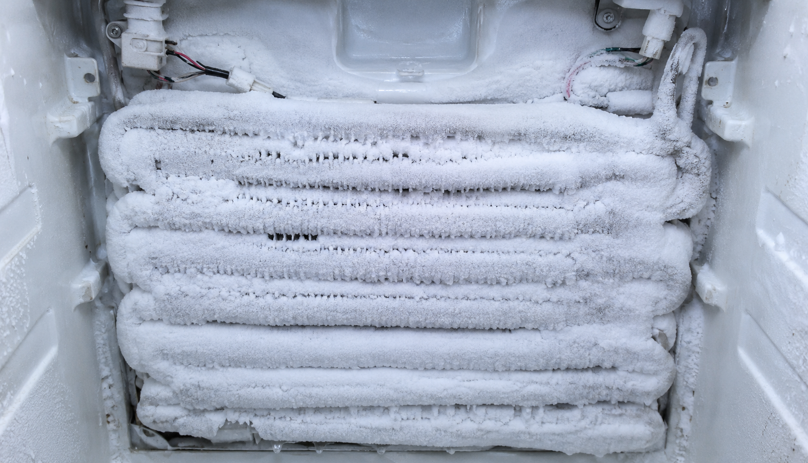 ChatGPT Image Jun 16, 2026, 04_48_19 PM evaporator coils completely covered in thick frost inside freezer