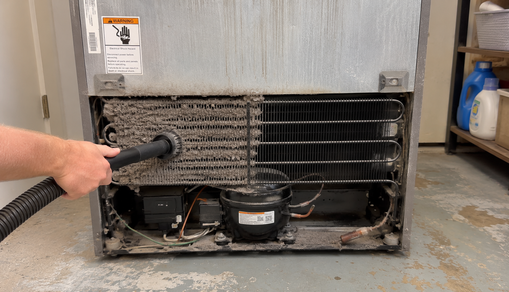 ChatGPT Image Jun 18, 2026, 08_50_23 PM cleaning dirty refrigerator condenser coils to fix compressor overheating