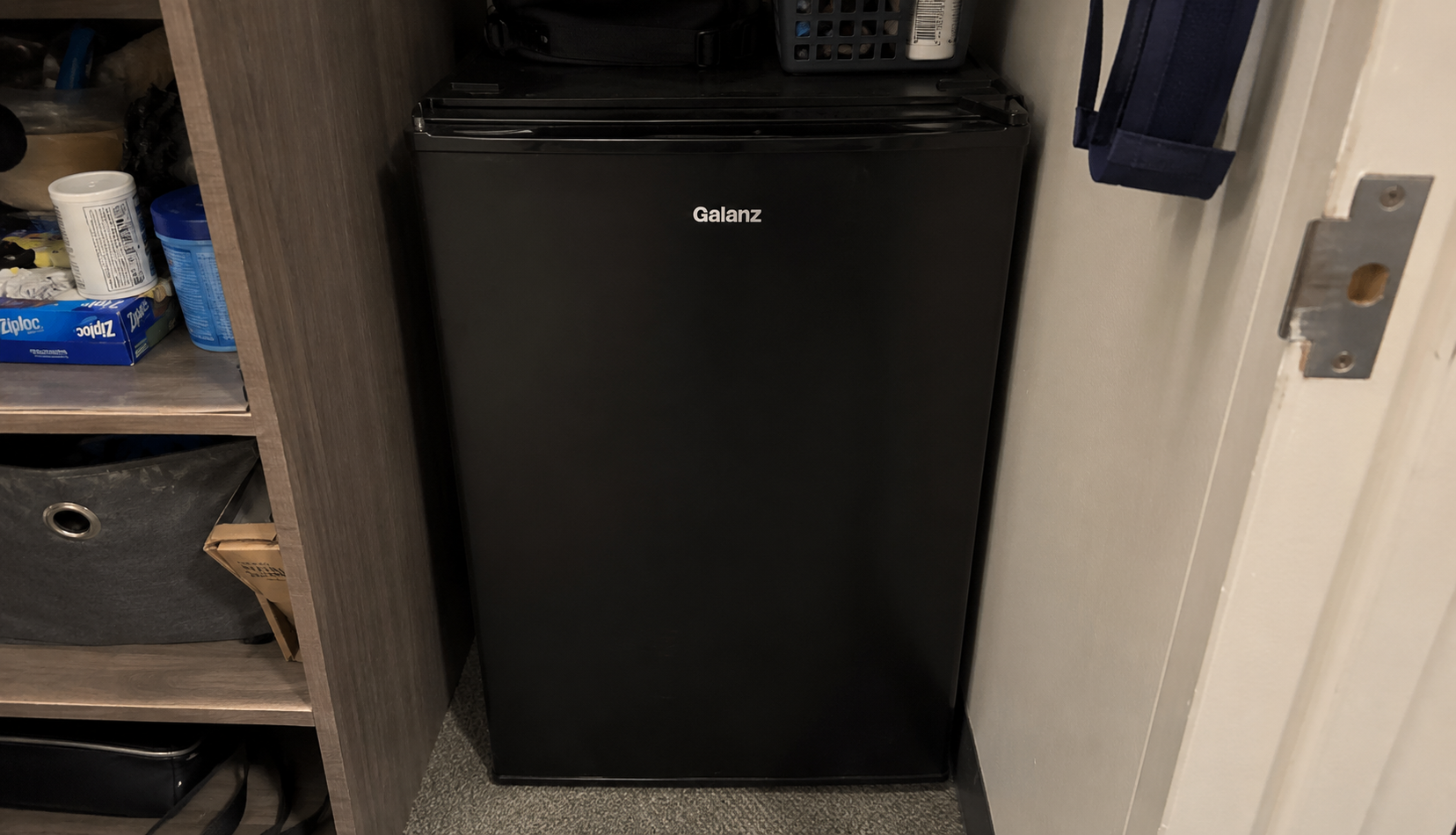 ChatGPT Image Jun 21, 2026, 05_13_28 AM mini fridge crammed into closet with no ventilation clearance
