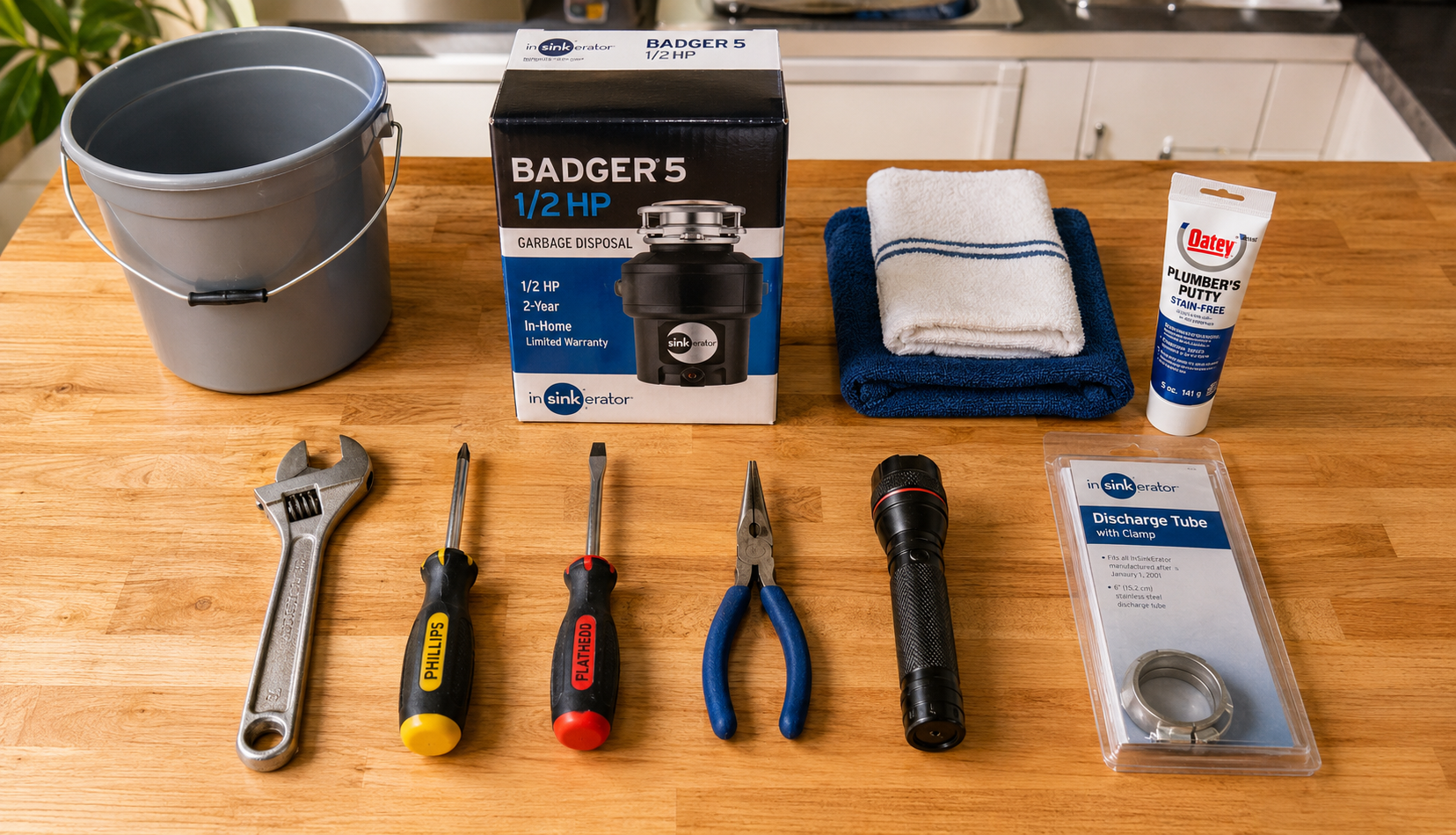 Tools and materials laid out for garbage disposal replacement installation