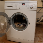Open washing machine drum with standing water after drain pump failure