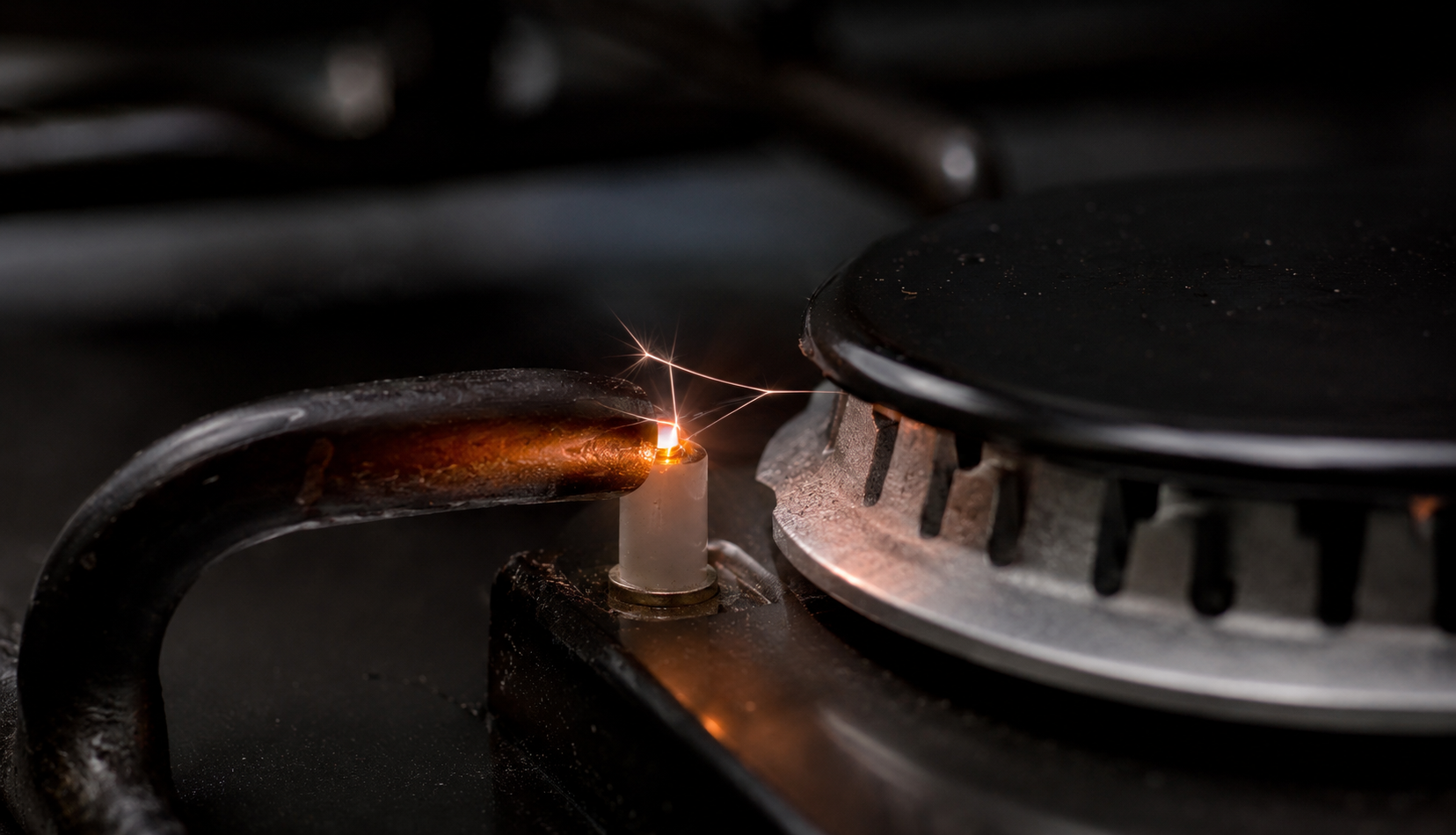 ChatGPT Image Jul 13, 2026, 09_57_16 PM Close-up of a gas stove igniter sparking near the burner