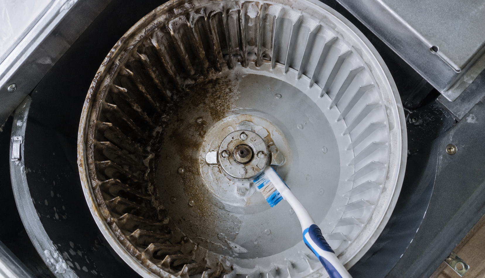 ChatGPT Image Jul 25, 2026, 12_15_18 AM Toothbrush scrubbing grease from range hood fan blades