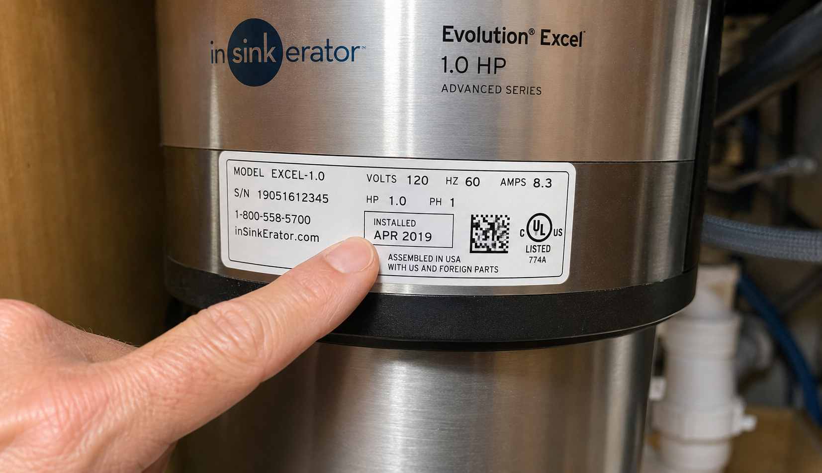 Checking garbage disposal installation date on unit nameplate label