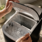 Opening a countertop ice maker to check for buildup